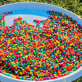 Colored Corn Kernels Sensory Bin Filler for Kids, featuring vibrant rainbow-colored corn kernels designed for sensory play, encouraging exploration, creativity, and fine motor skill development.